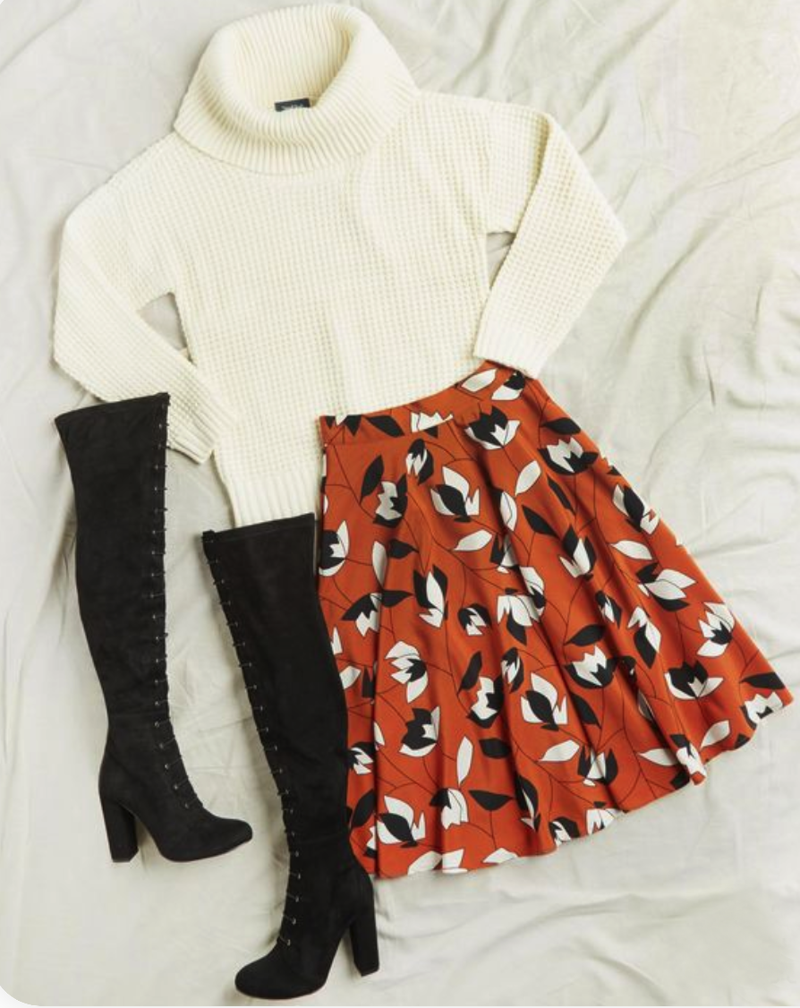 Snow white mock
                    neck sweater
                    with feather print red flowy skirt paired with black
                    knee
                    high boots